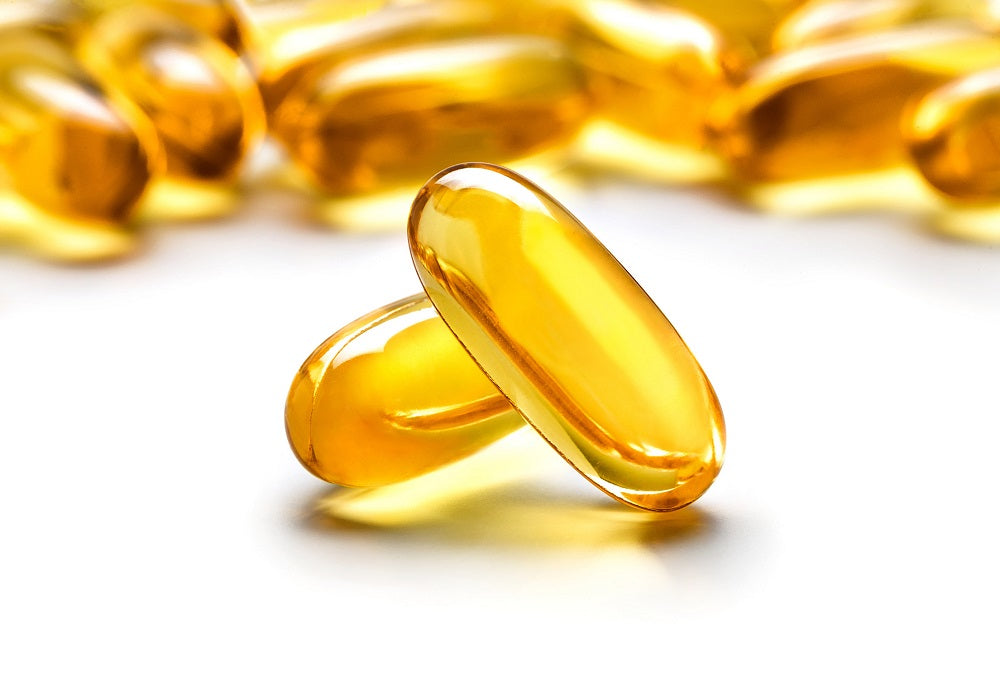close-up of a few yellow Omega-3 fish oil capsules