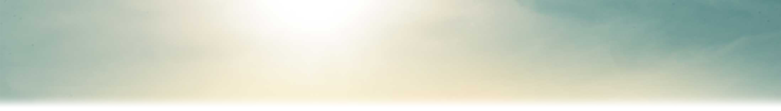 A blue sky with sunlight streaming through